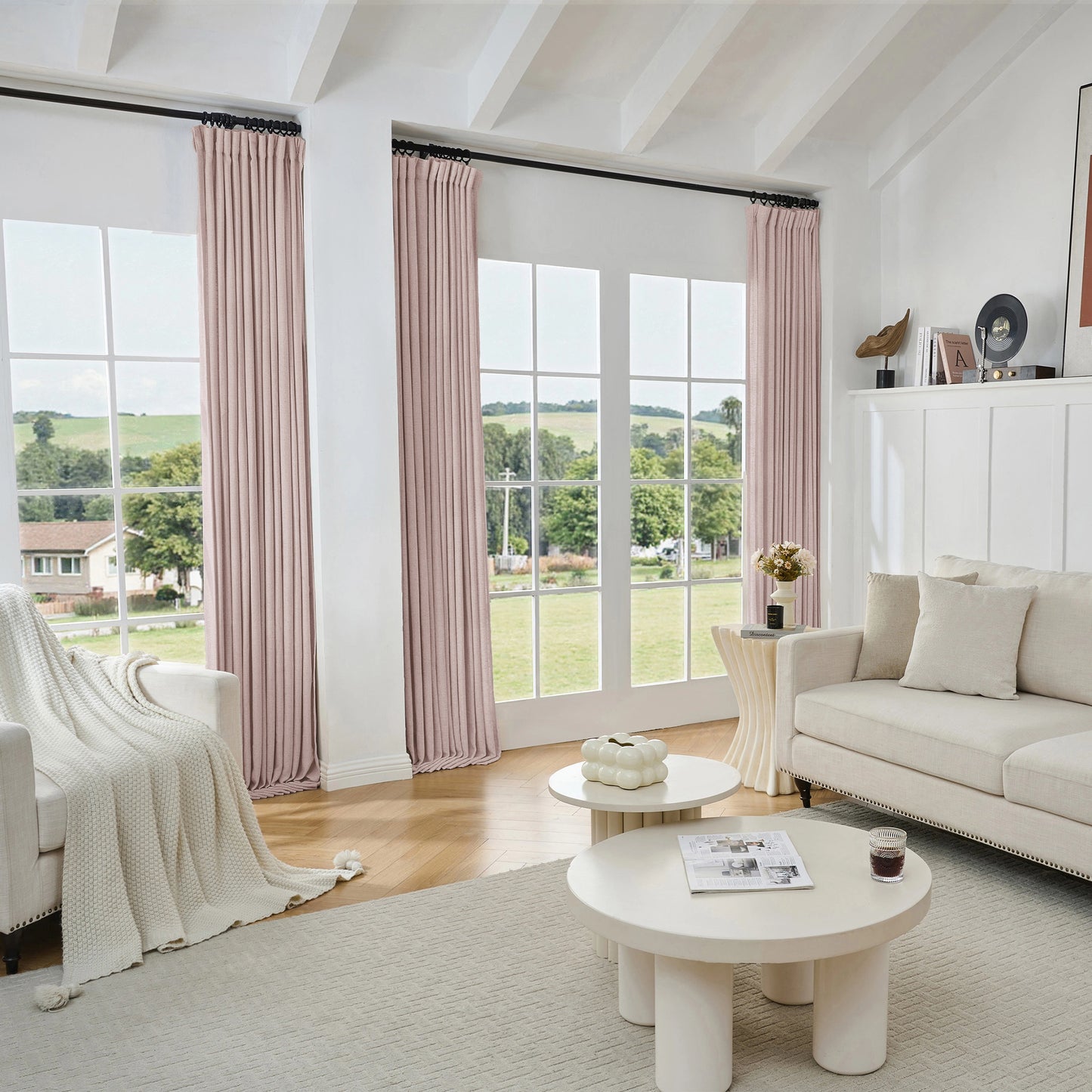 Living room with soft pink viscose, polyester, and linen mixed fabric curtain, white sofa, and tables.