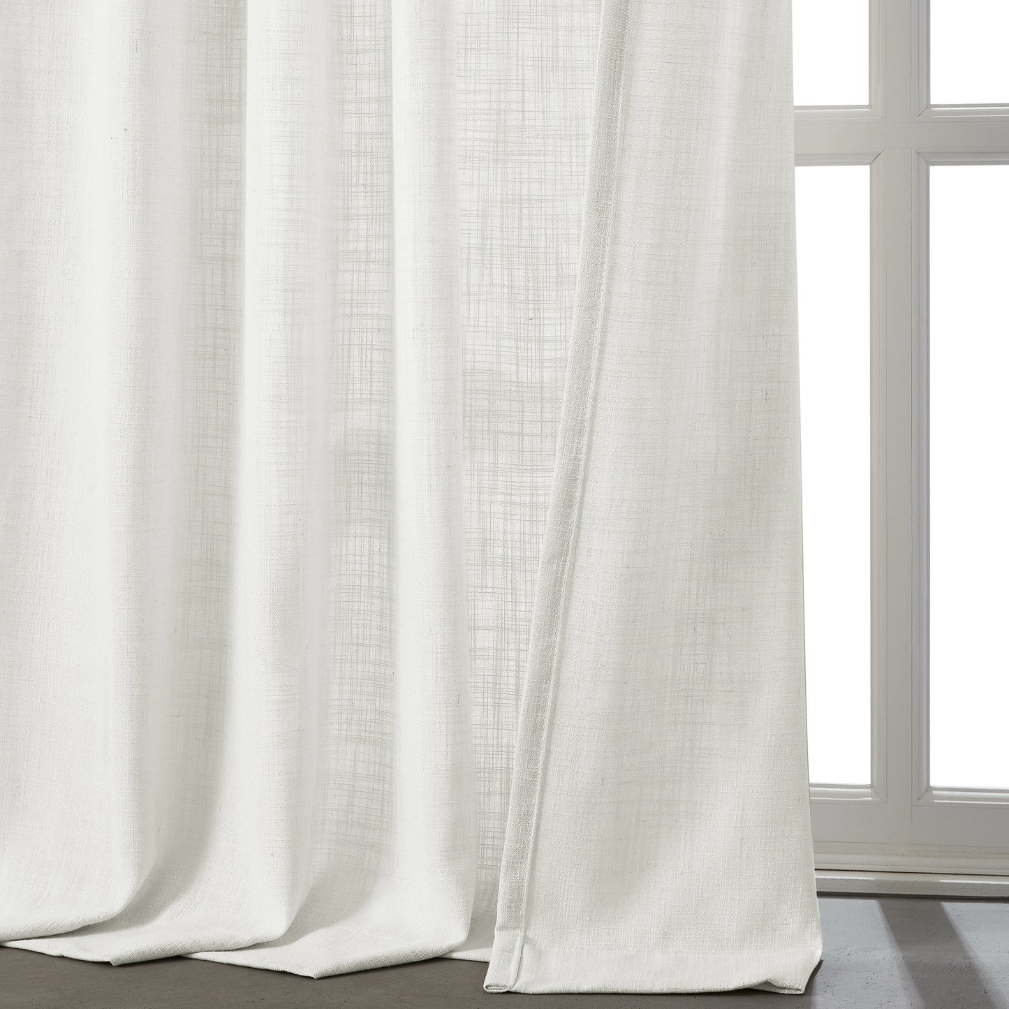Cool clean white linen-polyester blend lightweight curtain in front of a window.