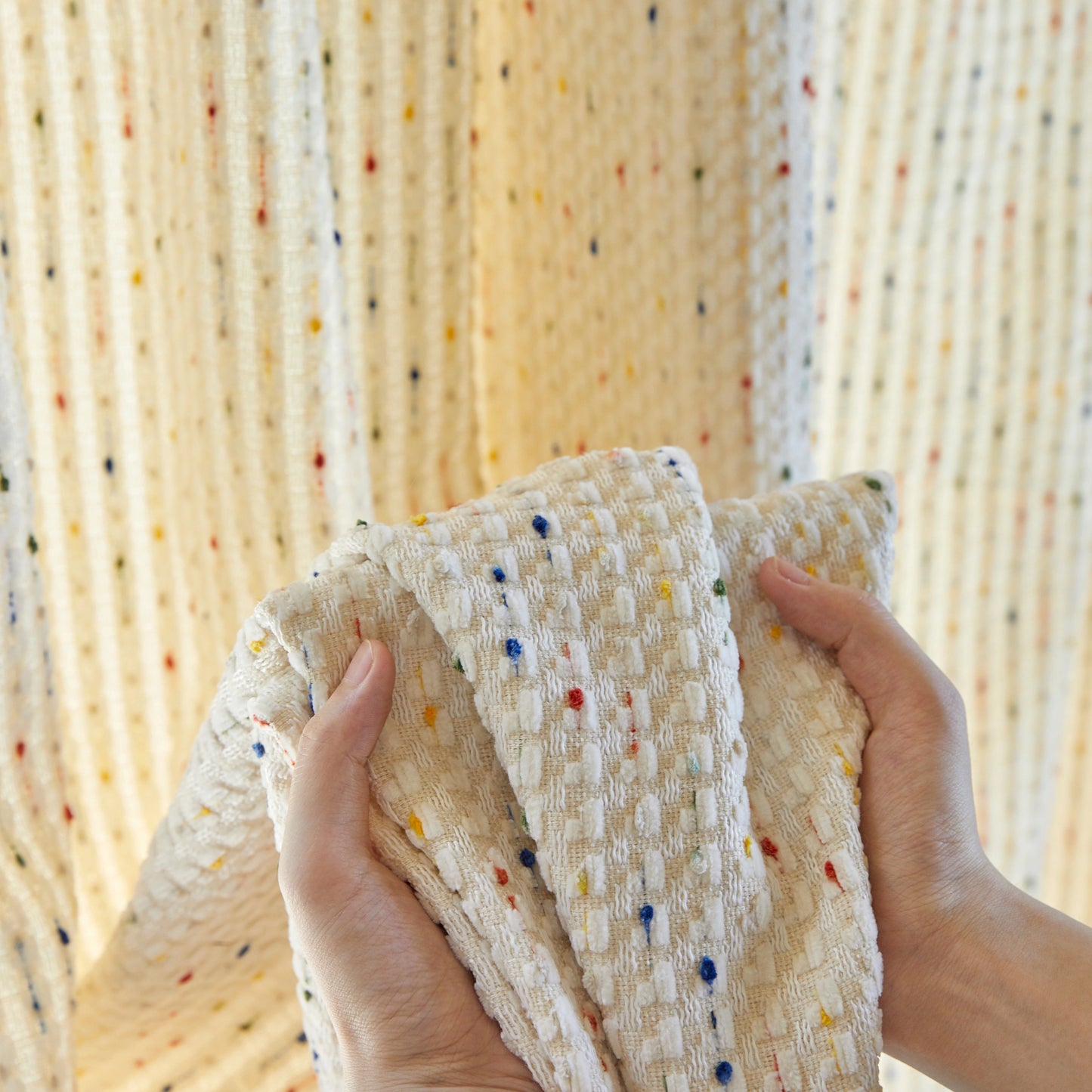 Close-up of soft chenille fabric, highlighting its plush texture and comfortable hand feel