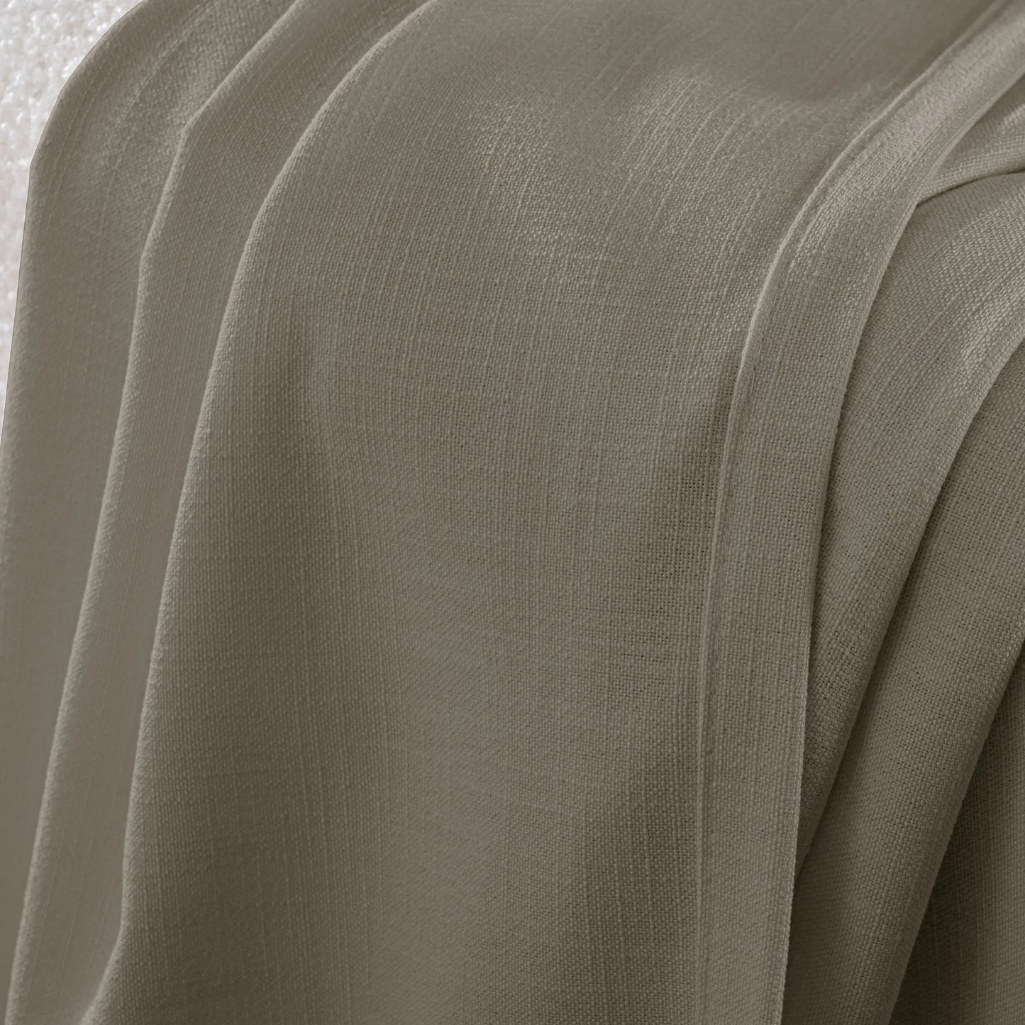 Detail of an taupe flame-retardant polyester curtain with a slub-style texture and a thick, nubby weave pattern.