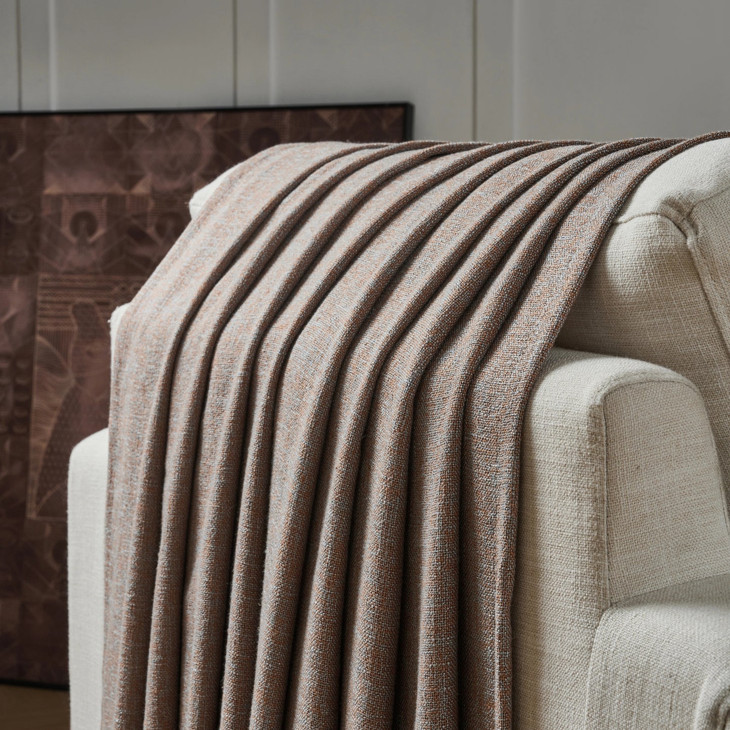 Burnt clay poly viscose linen curtain panel draped over a chair with a neutral background.