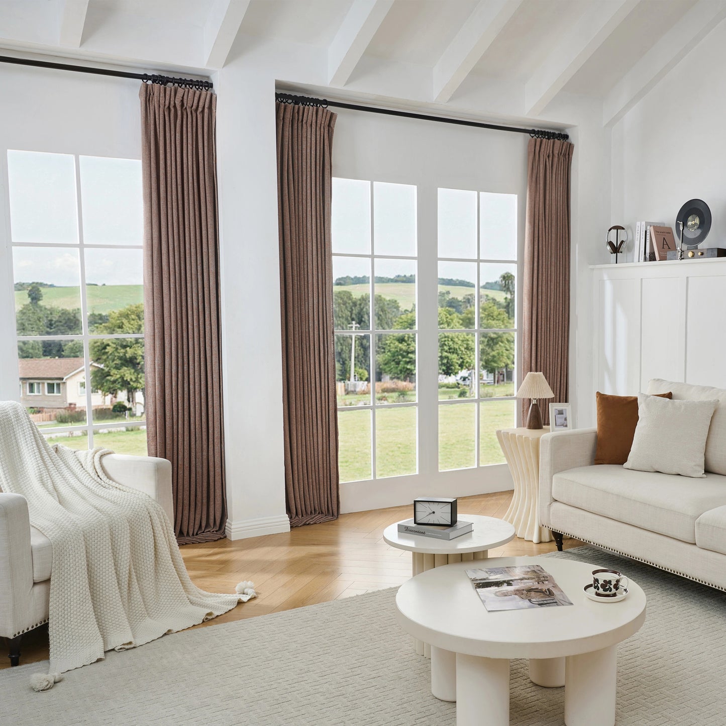 Living room with large windows, clay brown poly-viscose-linen-drapery, and a white sofa.