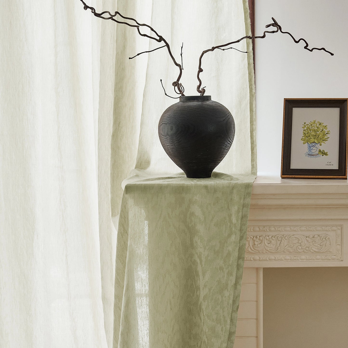 Green jacquard wool-blend sheer curtain with subtle woven texture, softly lit beside a French-style window.