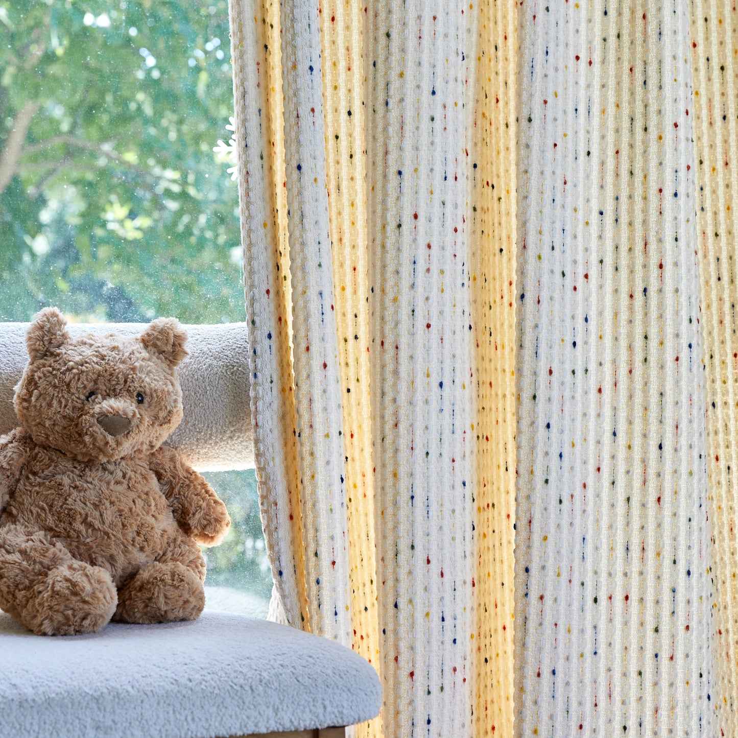 Textured curtains by the window, showing subtle vertical texture and natural drape