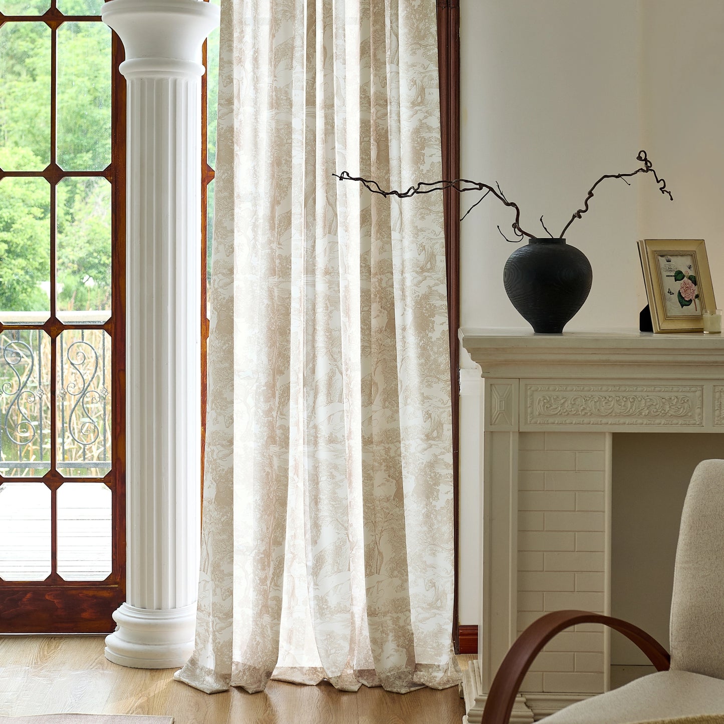 Living room with draped walnut toile voile curtains, a chair, and decorative decor items.