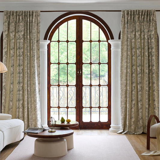 Living room styled with sage toile back tab curtains in cashmere-like fabric, with a sofa, table, and decorative items.