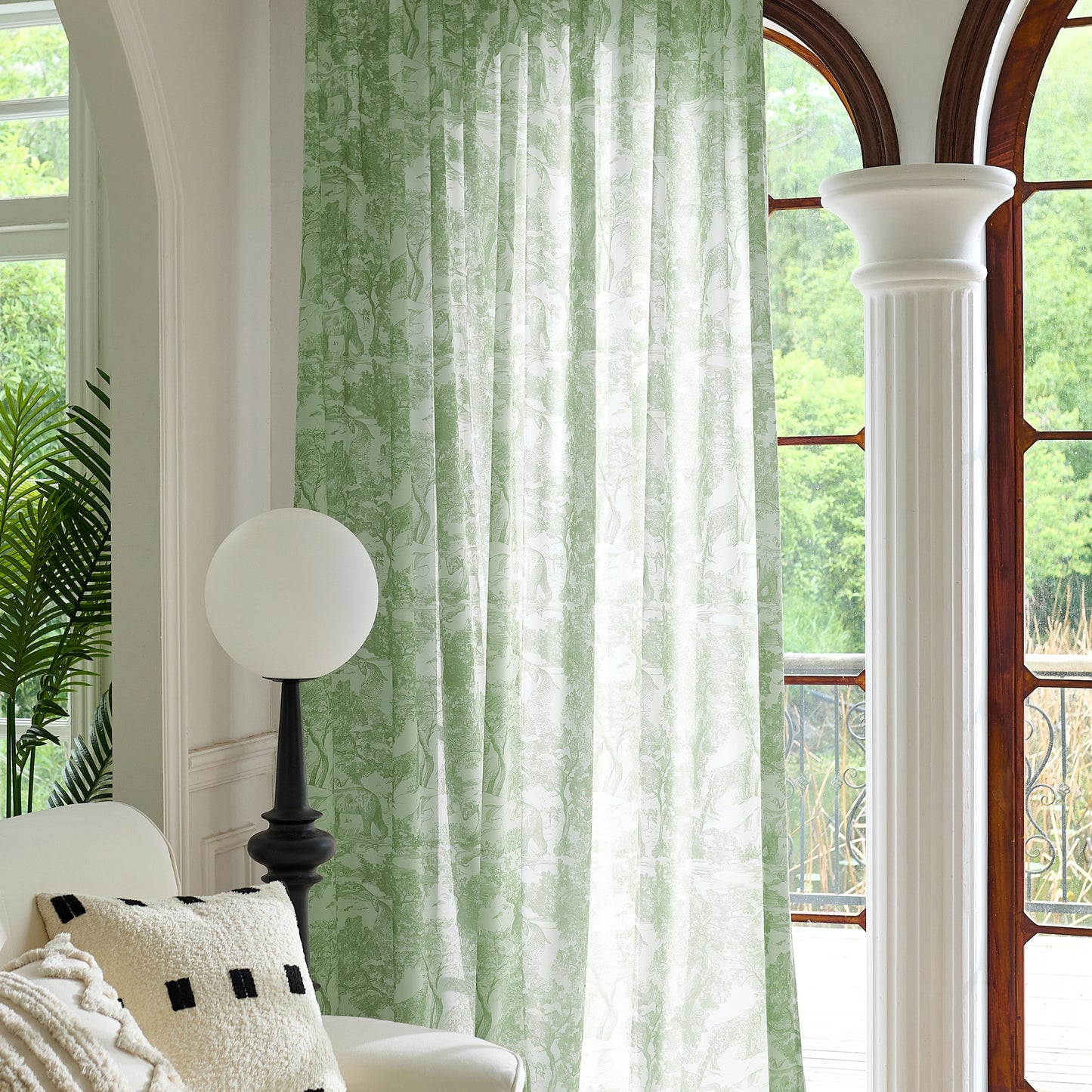 Green toile sheer curtains softly filtering natural light, creating an elegant and airy living space