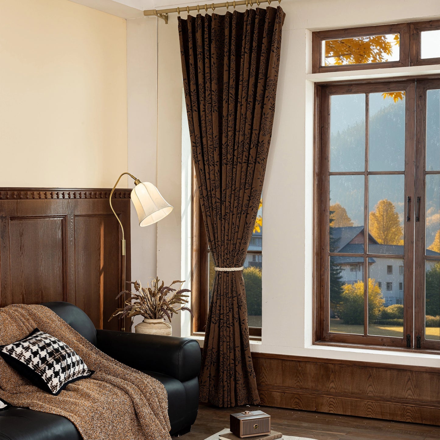Room with vintage warm umber curtains in a deep floral motif, furnished with a sofa and lamp.