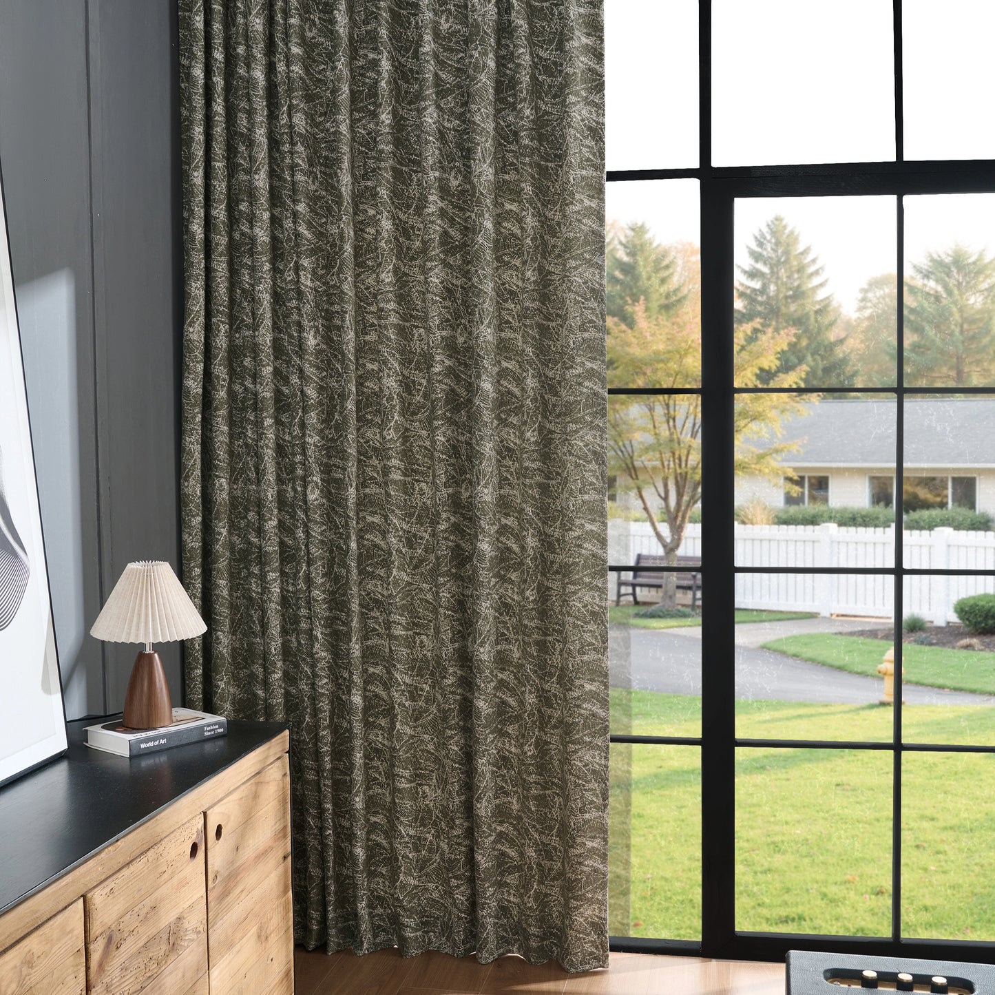 Vintage sage curtain panel featuring a rock-like texture, with the neighborhood visible through the window.