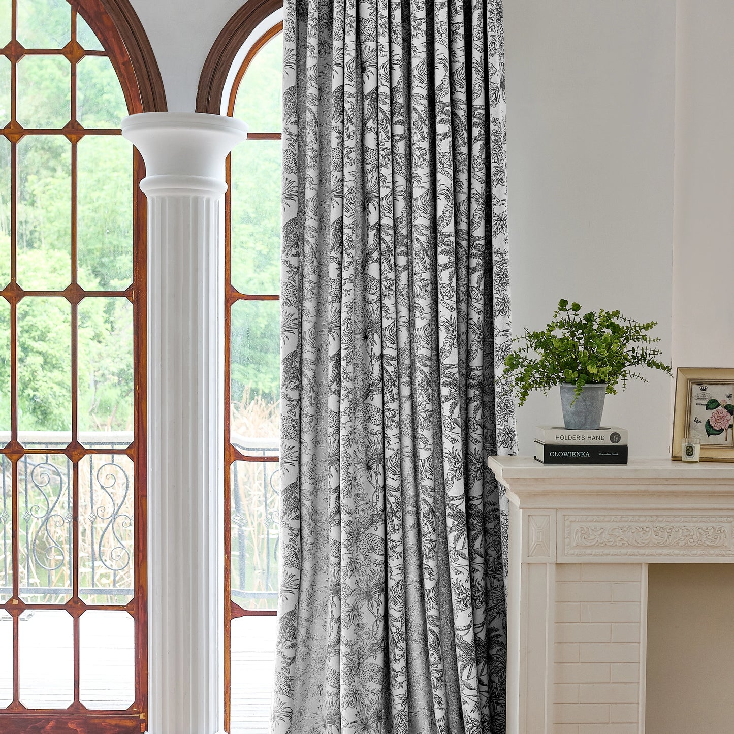 Black and white toile patterned curtains with a soft, plush feel, creating an elegant and timeless living room