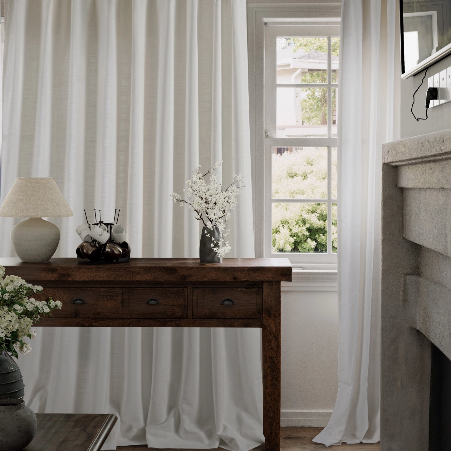 Wooden table with decorative items and ivory 100% polyester fire-resistant slub curtains.