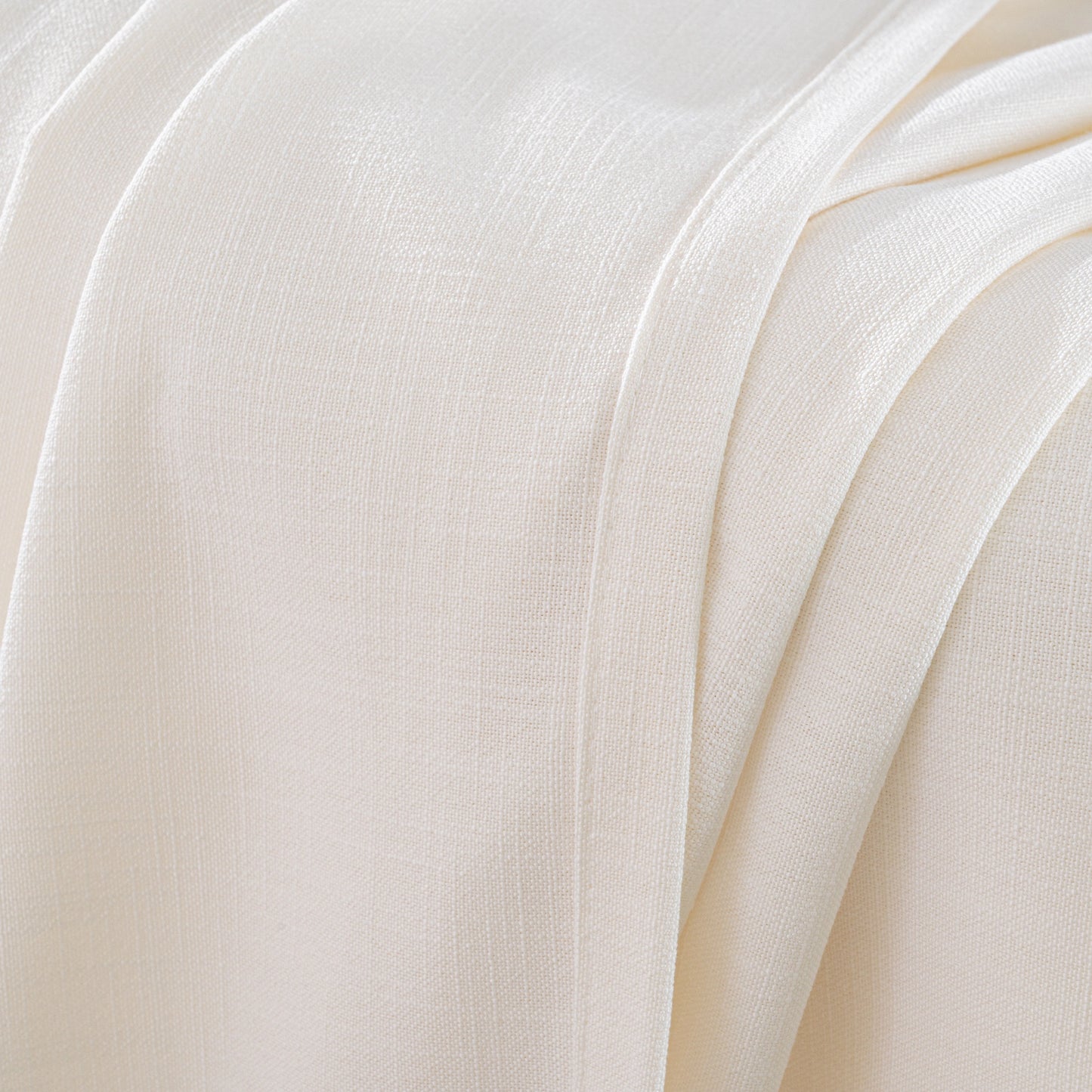 Detail of an off-white flame-retardant polyester curtain with a slub-style texture and a thick, nubby weave pattern.