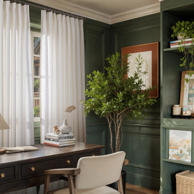 Room with a desk, chair, decorative elements, and cream polyester fire-safe slub-weave curtains.