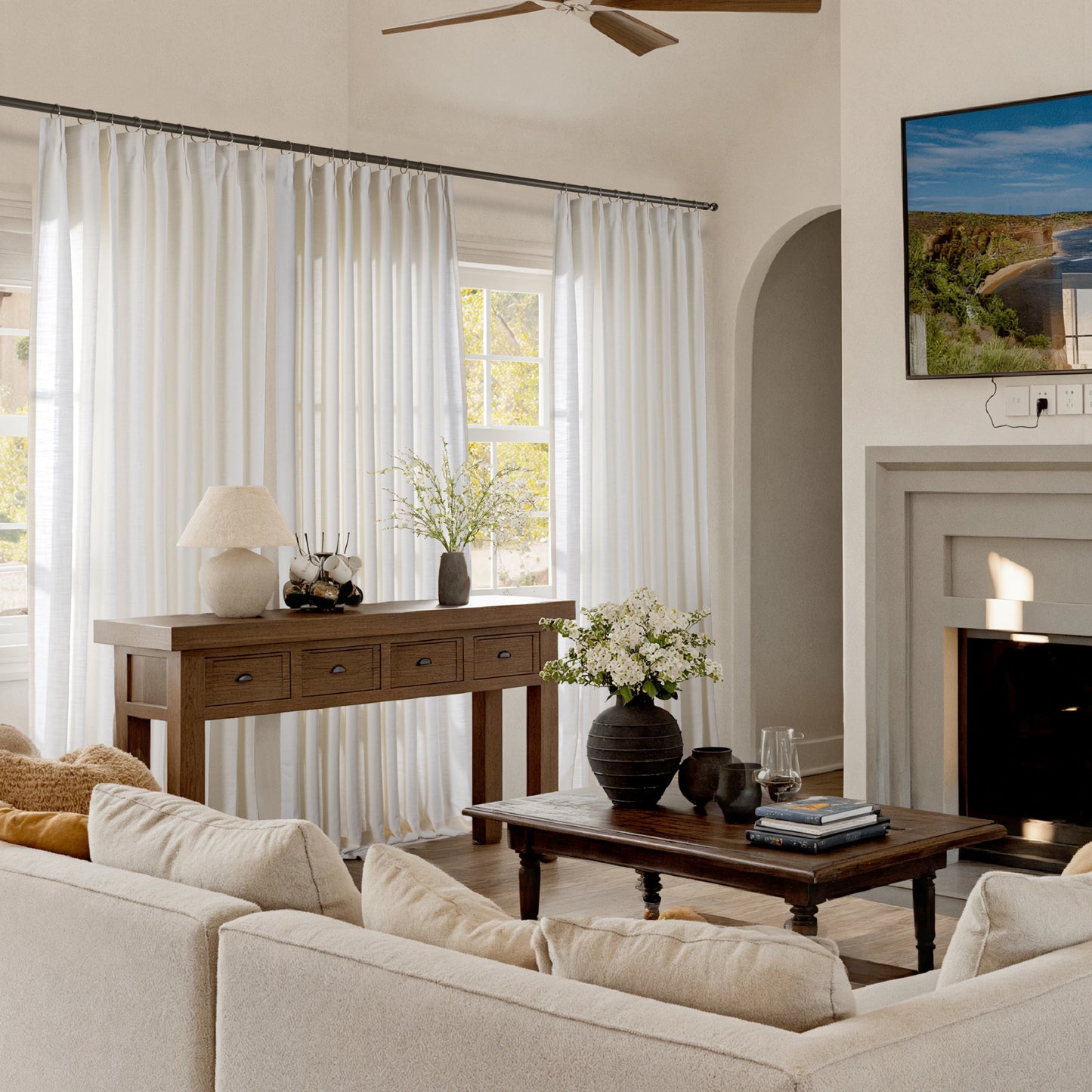 Living room with a beige sofa, wooden table, wall-mounted TV, and light-neutral polyester flame-resistant textured curtains.