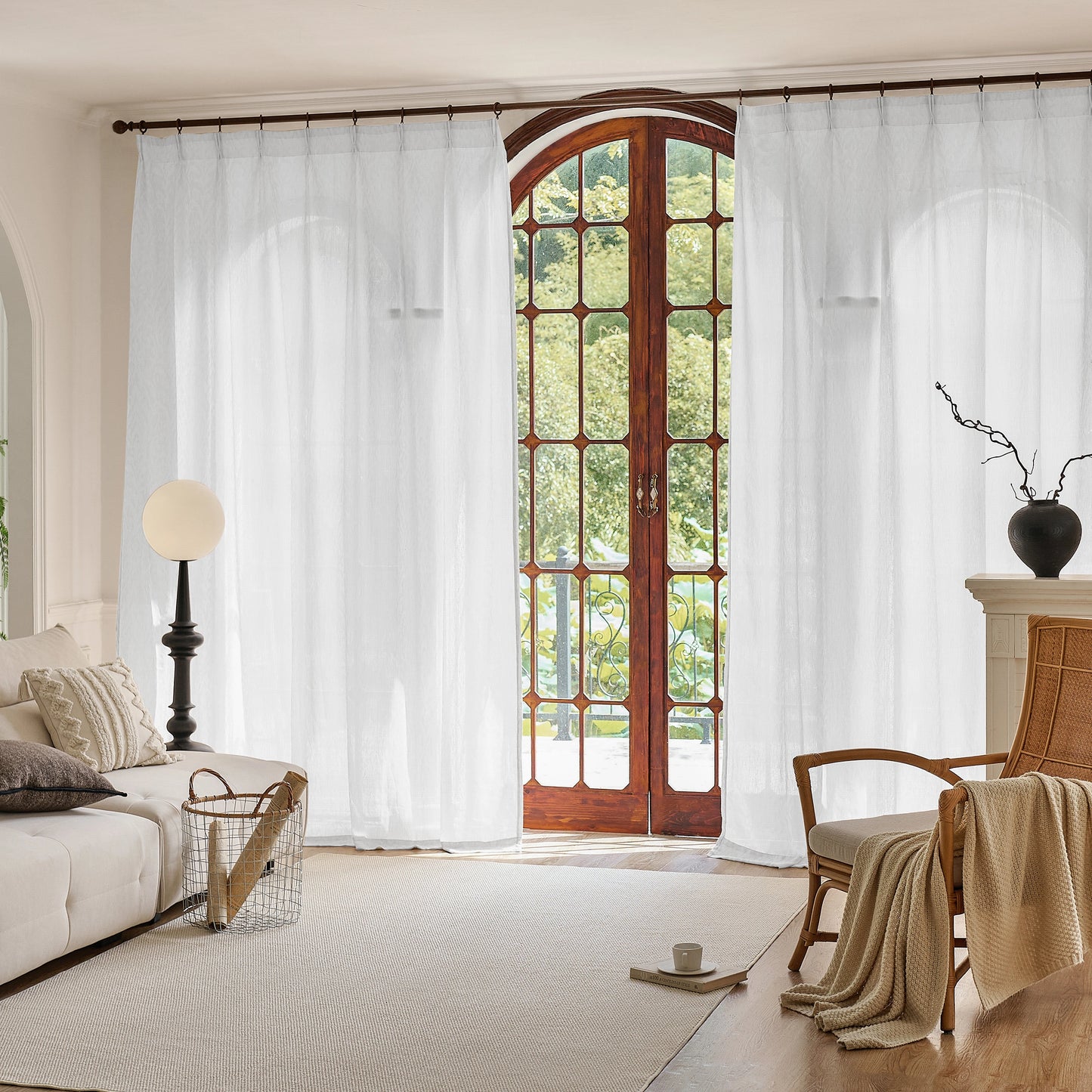 Living room with white wool blend sheer, wooden French door, and beige sofa.