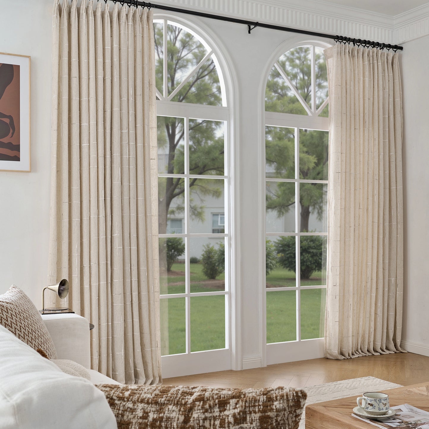 The living room features fawn raised textured curtains, with a wooden table and sofa in front.