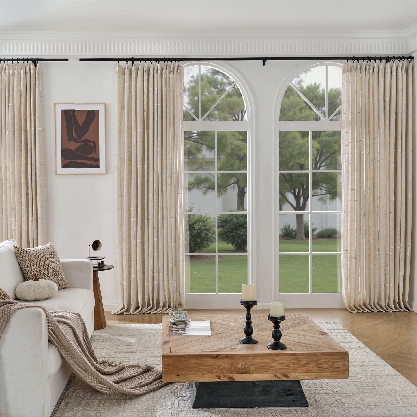 Living room with a wooden table, sofa, and large windows with ecru wool–poly blend curtain with tactile raised pattern.